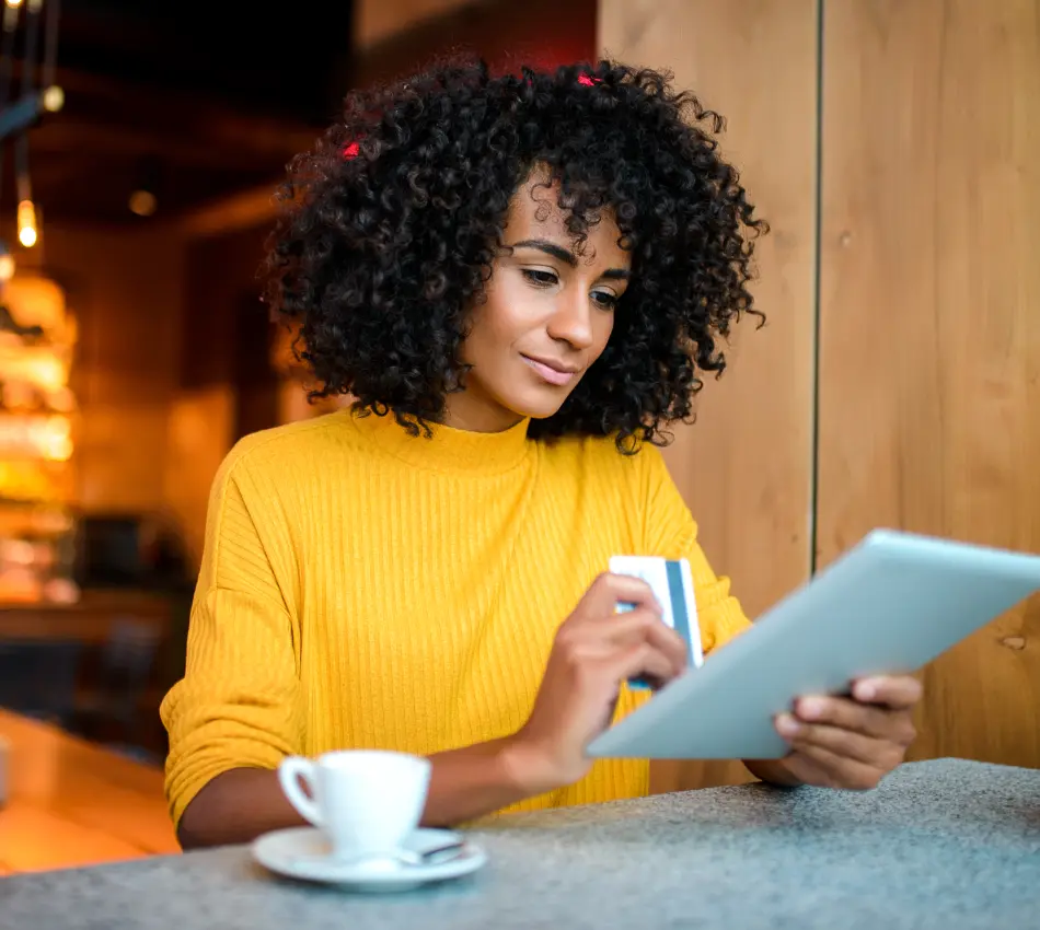 A small business owner issues a credit card to her employee via her tablet.