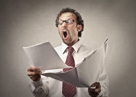 Businessperson surprised by paperwork