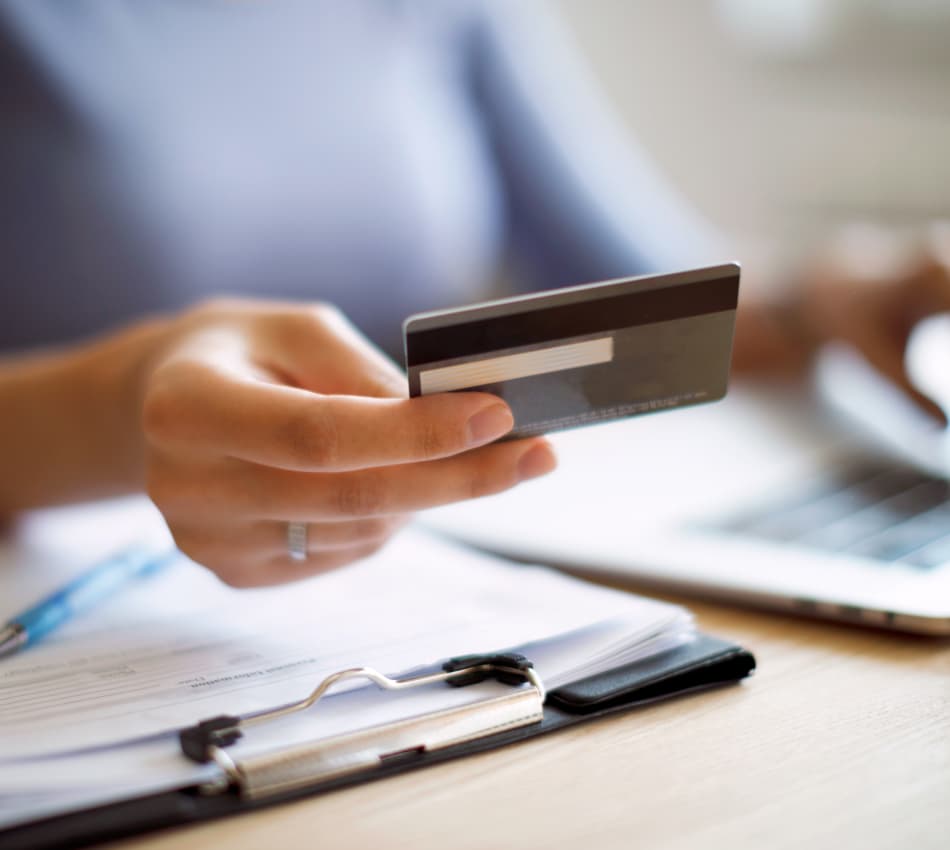 Close-up of hand holding a business credit card.
